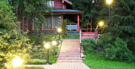 A well-lit walkway with outdoor lighting.